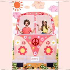 two children in a pink van with flowers and peace signs