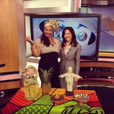 two women standing next to each other in front of a table with decorations on it