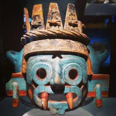 an old mask is on display in a museum