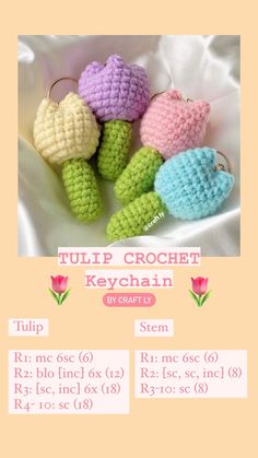 four crocheted turtle keychains sitting on top of a white cloth covered table