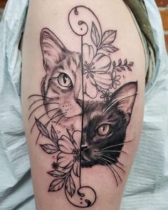 a woman's arm with a cat and flower tattoo on the left side of her thigh