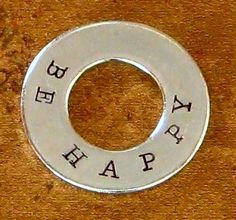 a metal ring with the words happy on it