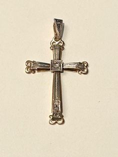 18 carat gold cross. Art Nouveau style. Two tone white and yellow gold With 8 rose cut diamond, one in the centre apr.0.10k the rest of the diamonds (7) are apr. 0.02k. The cross is hallmarked 750 for 18k gold.  The measurements are: length: 4cm, width:2.5cm. Will be sent in a jewellers box, ready for a present. White Gold Cross Charms For Anniversary, Classic Formal Cross Necklace With Diamond Cut, Classic Diamond Cut Cross Necklace For Formal Occasions, Formal Diamond Crucifix Cross Necklace, Formal White Gold Cross Necklace With Diamond Cut, Yellow Gold Brilliant Cut Cross Necklace, Elegant White Gold Cross Charm, Diamond Cut Crucifix Cross Necklace For Anniversary, Elegant White Gold Cross Jewelry And Charms