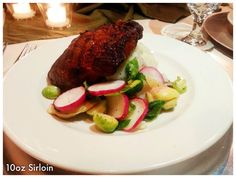 a white plate topped with meat and veggies