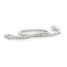 Indulge in timeless elegance with our 2cttw Diamond Tennis Bracelet. Crafted in 14k white gold, this bracelet sparkles with 81 round diamonds, I color and SI1 clarity. Measuring 2.21mm wide and 7" long, it features a box closure with two figure 8 safety clasps. Elevate any look with this luxurious piece. 14k white gold81 round diamonds, I color, SI1 clarity, 2.00ctwmeasures 2.21mm widebox closure with two figure 8 safety claspsmeasures 7" longClosure:SlideColor:White.Main Stone:DiamondMain Stone Luxury Everyday Diamond White Tennis Bracelet, Luxury Diamond White Diamante Bracelet, Luxury Diamond White Diamond Bracelet, Luxury White Gold Bracelets With 17 Jewels, Classic Luxury Diamond White Bracelet, Elegant White Diamond Bracelet Luxury, Luxury Diamond White Platinum Tennis Bracelet, Luxury White Diamond Bracelet In Sterling Silver, Luxury Round Diamond White Diamond Bracelet