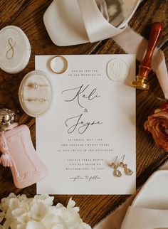 the wedding stationery is laid out on top of the table