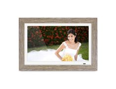 a woman holding a bouquet of flowers in front of a white background with a wooden frame