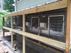 an outdoor area with several cages on the porch