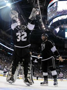 two hockey players are congratulating each other on the ice