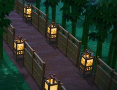 several lanterns lit up in the middle of a path