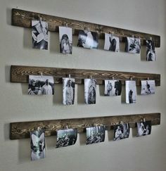 several pictures are hung on the wall with clothes pins attached to them and hanging from wooden pegs