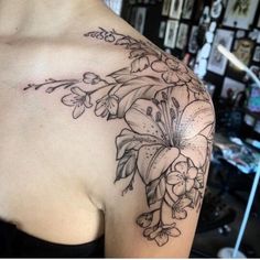 a woman with a flower tattoo on her shoulder