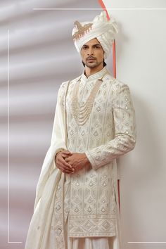 Top Details Color- Off White, Fabric - Soft Blended Silk With Embroidered Bottom Details Color- white, Fabric - Dhupion Silk, Style - free size churidar Package Include :INCLUDES 1 SHERWANI,1 KURTA,1 CHUDIDAR AND 1 STOLE Turban ,Mojari And Other Accessories Are Not Sold Along With The Dress. CARE: DRY CLEAN ONLY Additional Information : - As This Sherwani/Waistcoat/Kurta Are Made As Per Orders So It Is Strictly Not Acceptable Once Get Delivered .So Kindly Choose Body Fit Size . Also We Keep 2 In Ceremonial Off-white Bandhgala With Intricate Embroidery, Ceremonial Off White Bandhgala With Intricate Embroidery, Reception Bandhgala With Pearl Embroidery, Elegant White Traditional Wear For Ceremonial Occasions, Elegant White Ceremonial Traditional Wear, White Ceremonial Sherwani For Festive Occasions, White Wedding Kurta With Dupatta, White Kurta With Dupatta For Wedding, White Sherwani With Resham Embroidery For Ceremonial Occasions