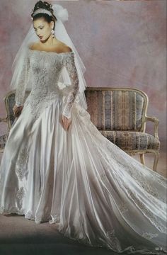 a woman in a wedding dress sitting on a couch