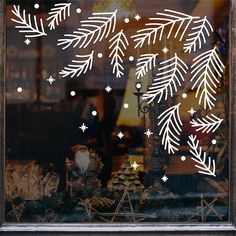 a window with snowflakes and christmas decorations in it