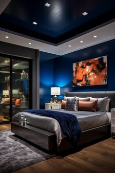 a bedroom with blue walls and wood flooring has a large painting on the wall