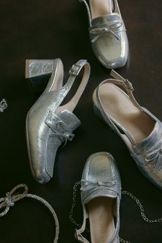 Slip into style with our Mini Ivy Bow Loafers in stunning silver. The square, closed toe design offers a sleek look, while the adjustable buckle at the side ankle ensures a secure fit. Perfect for adding a touch of whimsy to any outfit this holiday season. Holiday Shoes Christmas, Christmas Party Shoes, Winter Wedding Shoes, Holiday Heels, Silver Loafers, Sparkle Heels, Elegant Flats, Holiday Shoes, Embellished Shoes