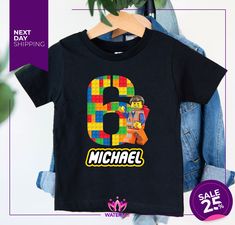 a black shirt with the number nine made out of legos and bricks on it