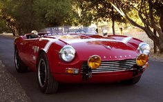 a red sports car is parked on the side of the road