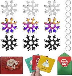 snowflakes and cards are being held by a person's hand in front of them