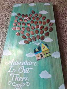 a wooden sign that says, adventure is out there with a house and balloons in the sky