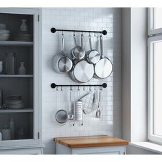 a kitchen with pots and pans hanging on the wall