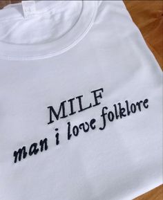 a white t - shirt with the words millf man i love folklore on it