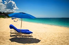 an umbrella and lounge chair on the beach