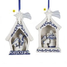 two ceramic christmas ornaments depicting the birth of jesus and mary in a manger scene