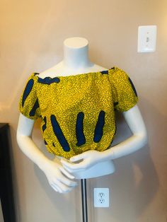 This vibrant Ankara top is perfect for the summer and all other occasions. Get noticed immediately in this vibrant yellow.  Pair it with overalls  Jeans, shorts and skirts  Very comfortable elastic band at shoulder line sleeves  and waist Simple Ankara Tops With Jeans, Kitenge Designs Dresses, Ankara Crop Top, Overalls Jeans, Ankara Blouse, Chic Evening Dress, Ankara Tops, African Tops, African Print Tops