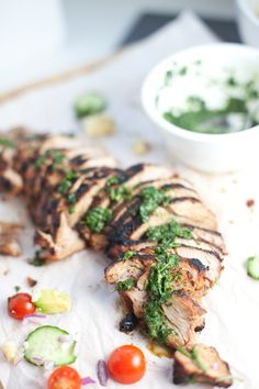 grilled chicken with pesto and cucumber garnish