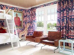 a living room with a bunk bed, chair and giraffe statue in it