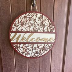 a welcome sign hanging on a door with the word'welcome'written in it