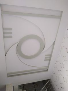 the ceiling is white and has a circular design on it