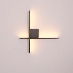 a square light fixture mounted to the side of a wall next to a white wall