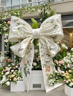 a large white bow with flowers around it