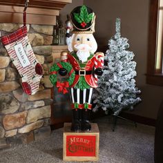 a christmas nutcracker statue sitting next to a fireplace