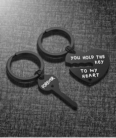 two keychains with the words you hold the key to my heart on them