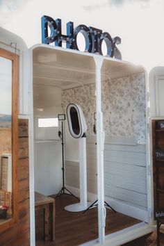 the inside of a horse trailer that is white and has blue letters on it,