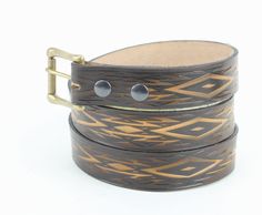 This Southwestern inspired belt is made from genuine leather. The geometric shapes leather belt is made in the USA from one piece of leather (which means no cardboard, plastic or glue). Next the hand tooled leather is sprayed with a resin finish for long lasting wear! Each belt is hand cut to size at the time of your order with 5 holes for flexible sizing and includes a leather keeper. The metal roller buckle with double snap closure make sure you can change the buckle anytime you would like. Up Leather Tool Belt, Modern Western, Tool Belt, Hand Tooled Leather, Genuine Leather Belt, Tooled Leather, Suspender Belt, Leather Tooling, Belt Size