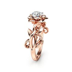 a rose ring with a diamond in the center and leaves on it's side