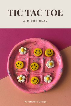 a pink plate with yellow smiley faces on it and the words tic tactoe air dry clay