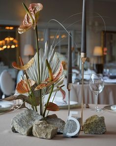 there is a vase with flowers in it on the table at this wedding reception,