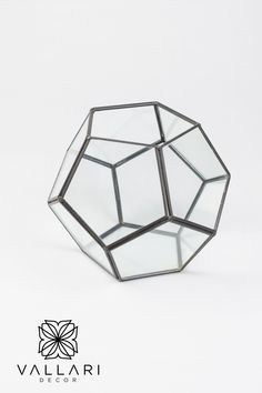 an octagonal glass object on a white background with the words valdari decor above it