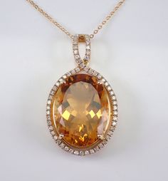 "14K Yellow Gold Diamond and Citrine Necklace with Chain. This necklace is set with an Oval Citrine and fifty-eight natural Round Brilliant Diamonds.  The Citrine measures 20 X 15 mm and weighs 16 carats. The diamonds in this pendant are H color, SI/I1 clarity and weigh a total of 1/2 carat.  The pendant is 14K Yellow Gold and comes with an 18\" 14K Yellow Gold chain and together weigh 7.9 grams. The pendant measures 35 X 20 mm. This necklace will be accompanied by an appraisal written by a GIA Luxury Yellow Gold Cushion Cut Necklace, Luxury Yellow Hallmarked Necklace, Luxury Brilliant Cut Yellow Gold Necklace, Luxury Orange Citrine Necklace, Luxury Yellow Single Strand Necklace, Yellow Stone Pendant, November Birthstone Jewelry, Pearl Necklace Designs, Citrine Jewelry