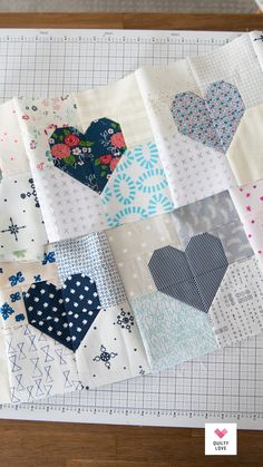 a close up of many different types of quilts on a table with scissors and thread