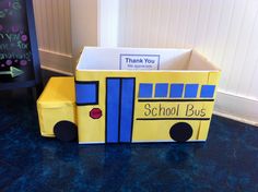 a cardboard school bus sitting on the floor