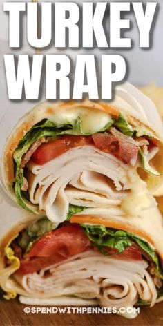 a turkey wrap with lettuce and tomatoes on it