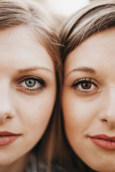 two beautiful young women standing next to each other with blue eyes and long eyelashes on their faces