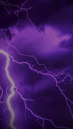 a purple and yellow lightning storm in the sky